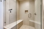 The master bathroom features a large walk in shower